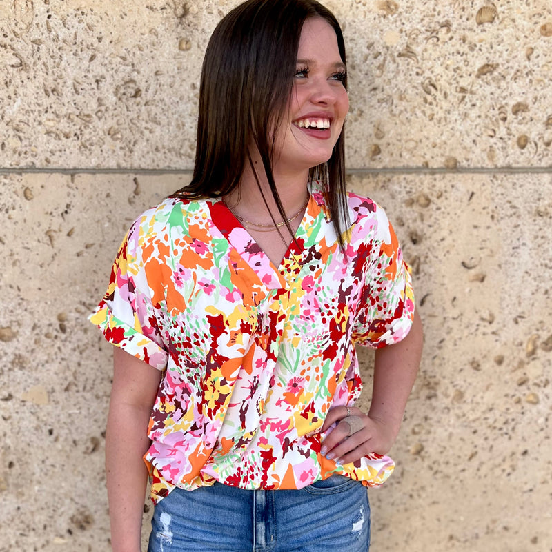Bring joy to your wardrobe this season with the stylish Summer Garden Top! This white shirt features a multi-colored, boho-inspired floral print, along with a flattering v-neck and short sleeves. Perfect for spring and summer days!  100% Polyester