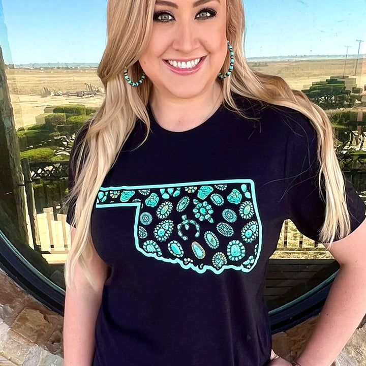 This PLUS size Oklahoma In Turquoise Tee is perfect for the fashion-savvy. Made from 100% Cotton, it features a bold Oklahoma state cutout and turquoise stone detail. Impress your friends with this stylish graphic black tee.