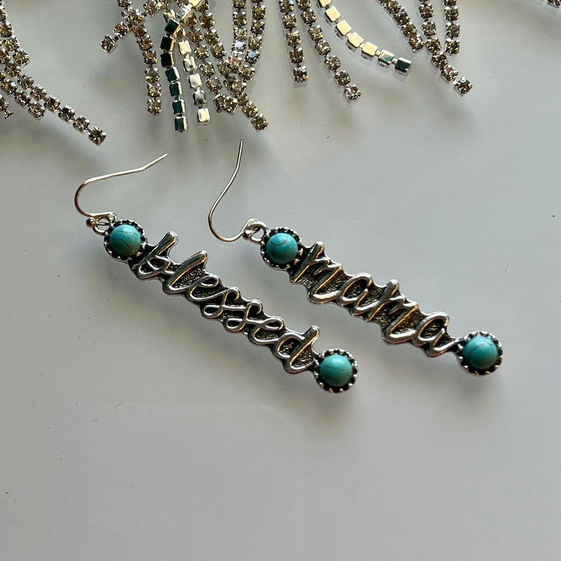 These Blessed Mama turquoise-embellished earrings are the perfect way to show off your stylish Western flair! The concho style design with silver dangle and fish hook fastening are sure to make a statement. Plus, the Blessed Mama message bar adds a special touch!  2 1/2" length