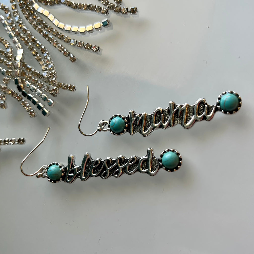 These Blessed Mama turquoise-embellished earrings are the perfect way to show off your stylish Western flair! The concho style design with silver dangle and fish hook fastening are sure to make a statement. Plus, the Blessed Mama message bar adds a special touch!  2 1/2" length