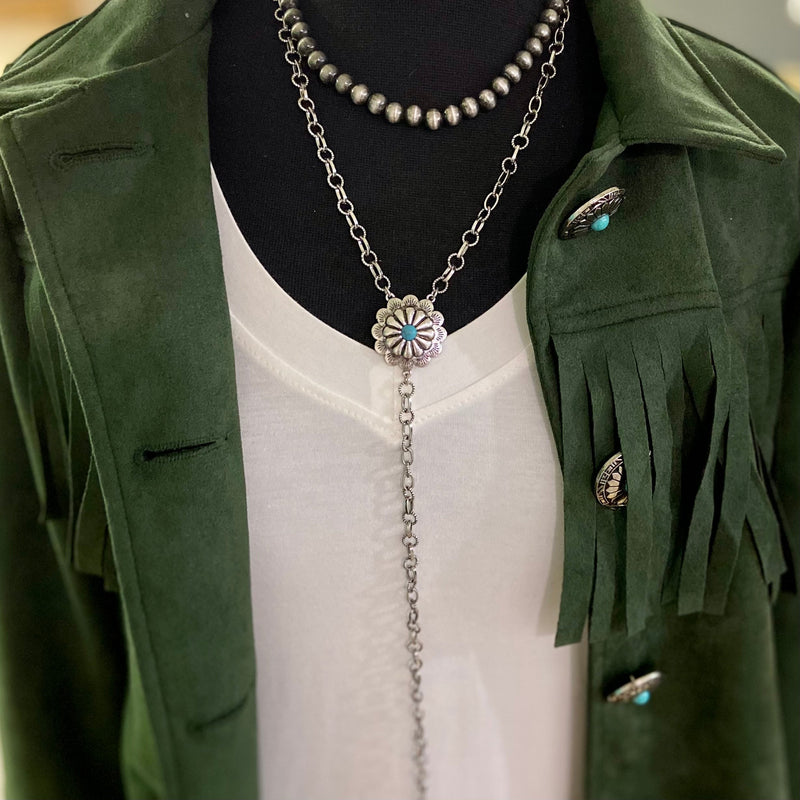 Eve's Addiction Layered Necklace is a 2 layered strand. One is a 8" faux buffalo pearl strand and the other is a 10" silver chain with a silver concho with a turquoise stone and then another 10" single chain dangling. This necklace is adjustable and can be worn with so many outfits. 