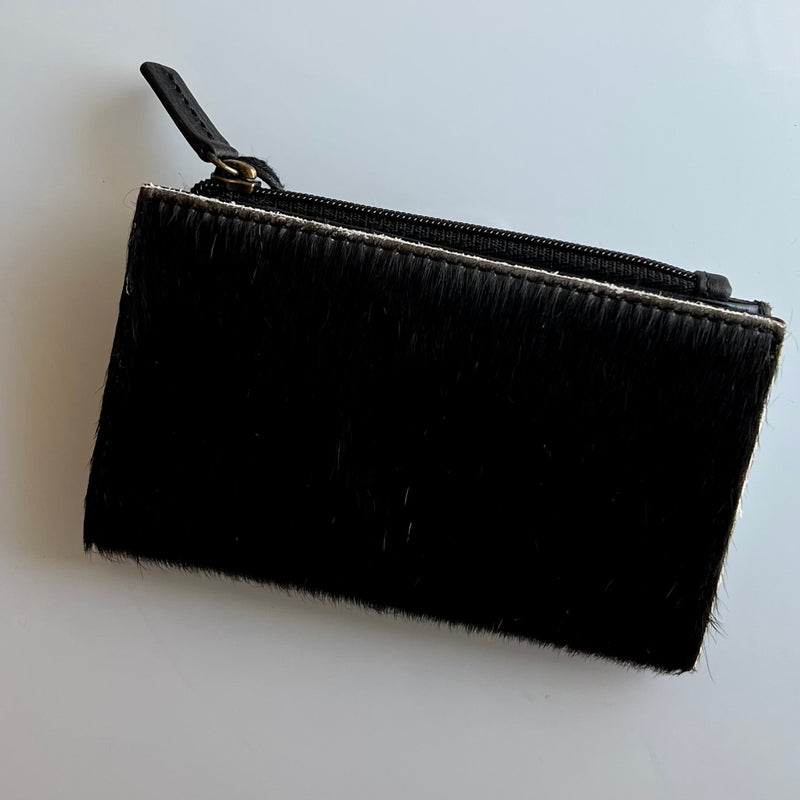 These Beautiful Hair On Hide Credit Card Holders are perfect for a handheld option. They are the perfect size to slip in your back pocket for a shopping day. Feature a zipper pouch for safe keeping, drivers license slot, and multiple credit card slots. They have a fold over snap closure as well.   Dimensions: 5" X 3"  **ALL HIDES WILL VARY**
