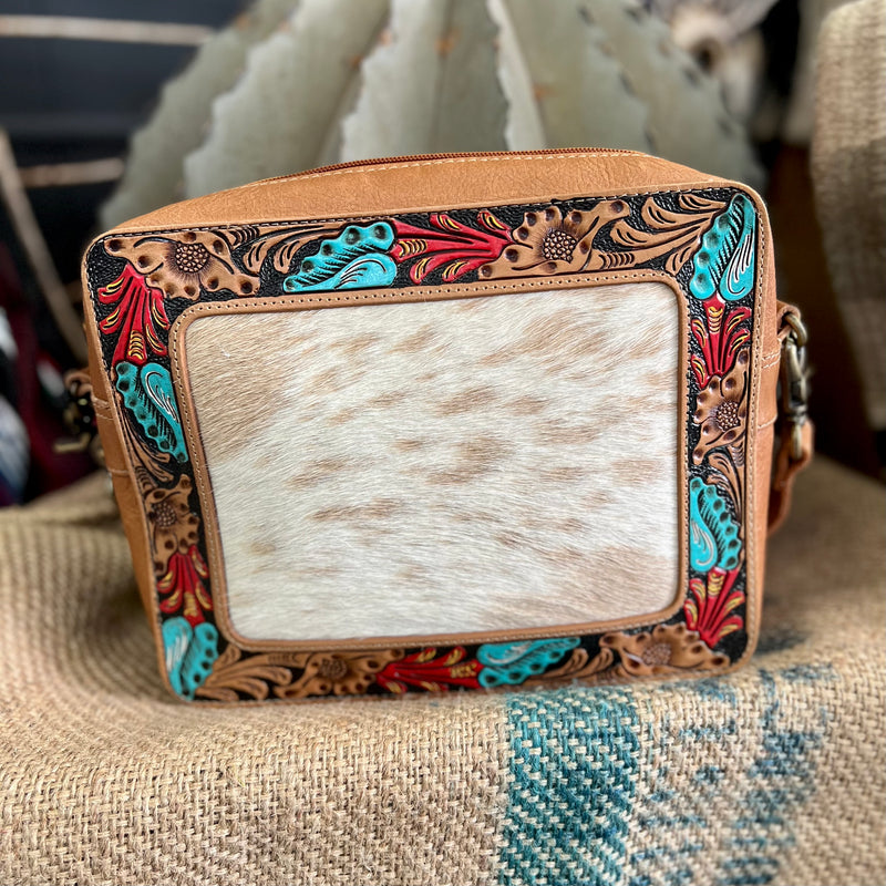 This beautiful Square Garden Bag features a hair on hide frame detail with an intricate turquoise and red painted floral pattern, complemented by brown leather.  With a 44" adjustable shoulder strap, you'll have the convenience and comfort you need to take everything you need on the go.  Dimensions: 10"W X 10"H
