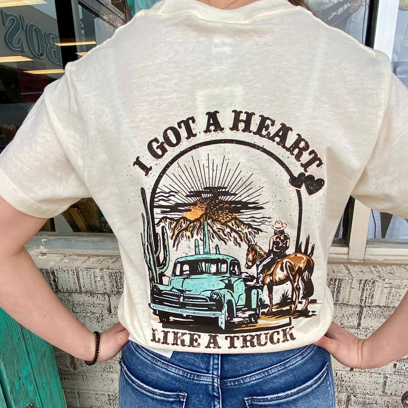 This PLUS size vintage-style tee, crafted with a relaxed fit and crew neck, is the perfect way to show your love for Heart Like A Truck. Featuring an almond color base and Heart Like A Truck Text graphic, this tee is sure to be a wardrobe staple.  50% Cotton, 50% Polyester
