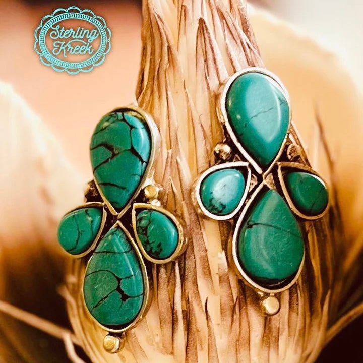 From the wilderness to your wardrobe, show the world who's boss with these eye-catching Fly Away Home Earrings! With four unique turquoise stones, you'll make a statement without saying a word. Comes with a free side of sass, so get ready to fly away in style.  LENGTH: 2"