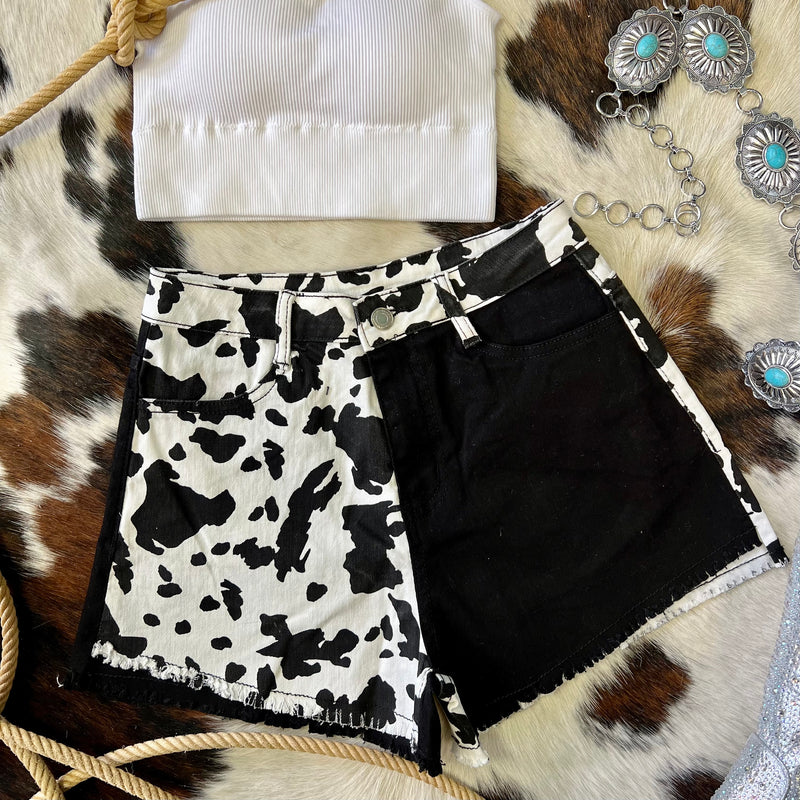 Our Milkshake Shorts are the "mooooo-t" fashionable addition to your summer wardrobe. Designed with classic western style, these black and white cow print denim shorts feature a slightly frayed hem and color block. Yee Haw!   Small Size 2-4  Medium Size 4-6  Large size 8-10
