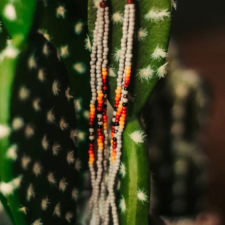 The Sonoran Desert Seed Bead Earrings are a 3 strand multi bead dangle earring on a fish hook back. The total length of the earrings are 4 1/2". The colors have a very southwest look.