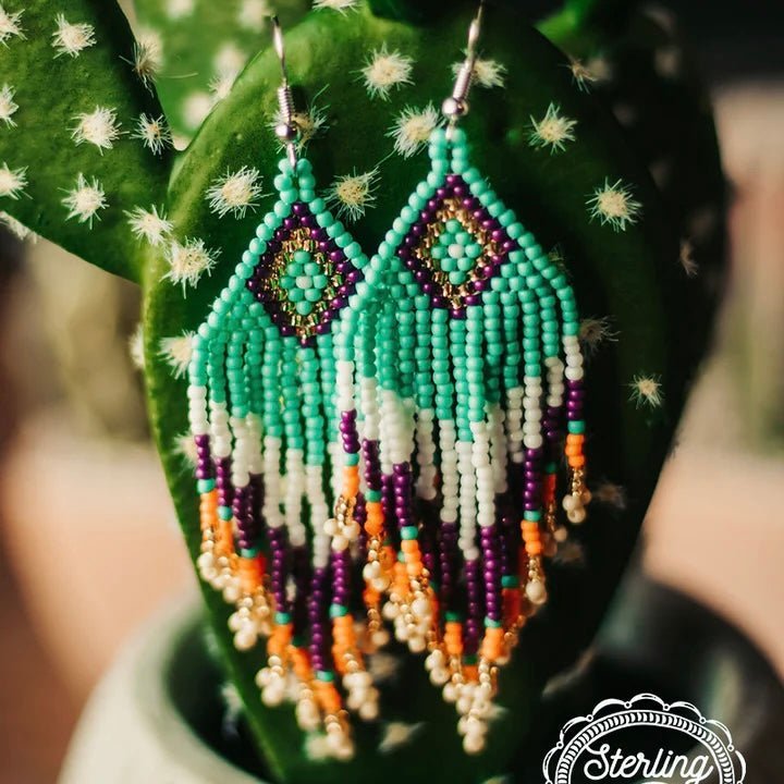 The Native Nation Seed Bead Earrings are a multi bead, multi strand, Aztec design dangle design. The colors really stand out and would add tons of color to any outfit. The total length of the earrings a 3 1/4". 