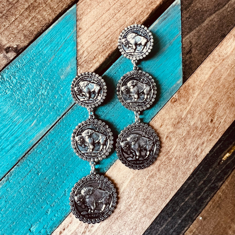 A 3 Tier  Buffalo design  on a round silver stamped cutout. The tiers are all different sizes. Small 3/4" in diameter, medium 1" in diameter, large 1 1/4: in diameter.   3"  in total Length