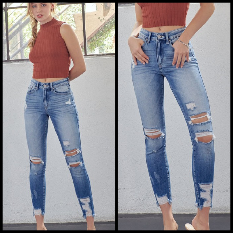 High rise ankle skinny jean with sand blasting distressing and rips with a frayed hem.