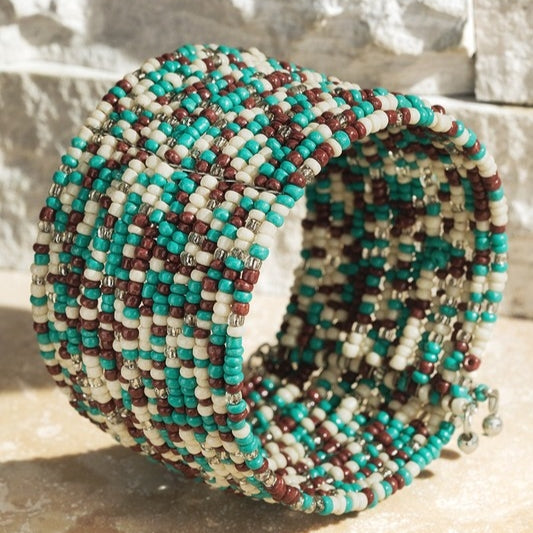 Eighteen strands of brown, turquoise, and ivory seed beads on a wire cuff.