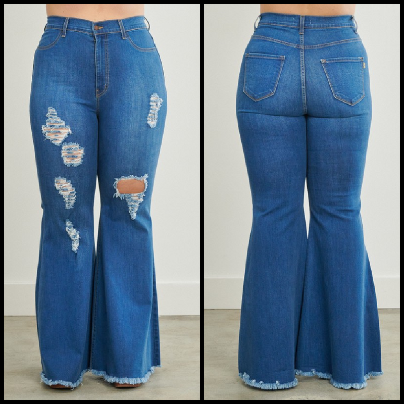 Super high waisted medium wash flare jeans with rips and raw frayed hems.  73% cotton, 14% Rayon, 11% polyester, 2% spandex  Inseam: 32"  Rise: 14"