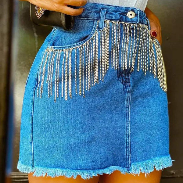 This Rhinestone Cowgirl Denim Skirt is a fashionable addition to your wardrobe. Crafted from quality denim, it features a chic pocket, a raw hem with rhinestone fringe tassels, and a zipper closure. Show off your unique sense of style with this western-inspired combination!