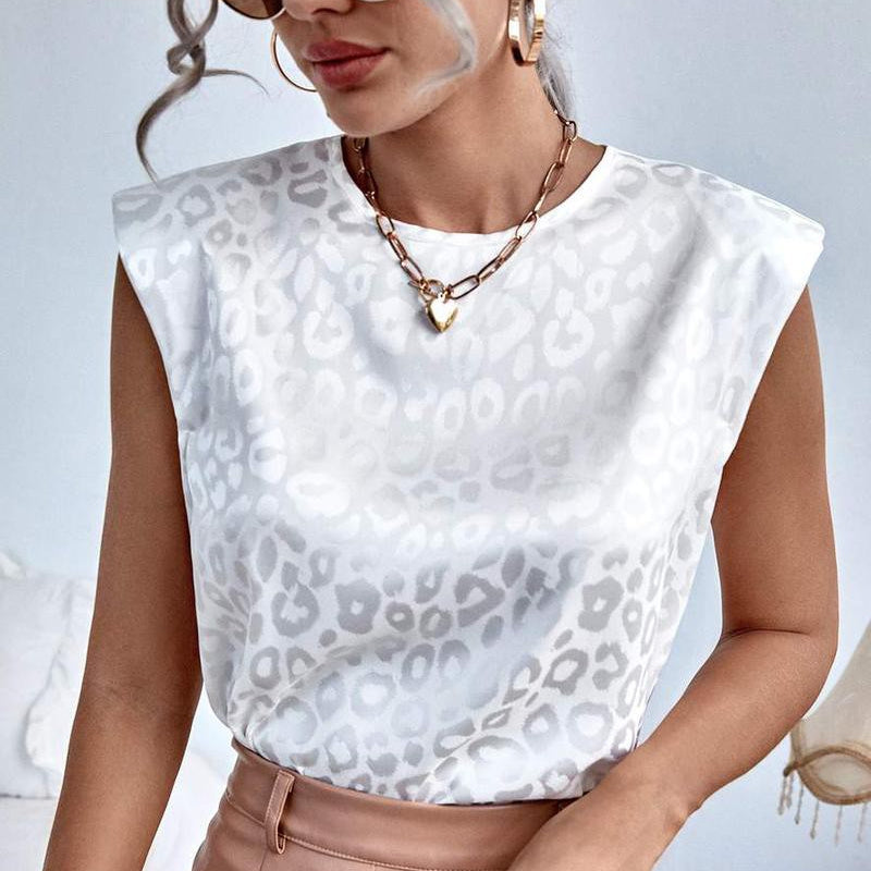 This beautiful white blouse is made from a satin crepe material that is sturdy, yet soft and flowy. Elegant leopard print detailing adds a touch of style, making it perfect for any formal occasion.