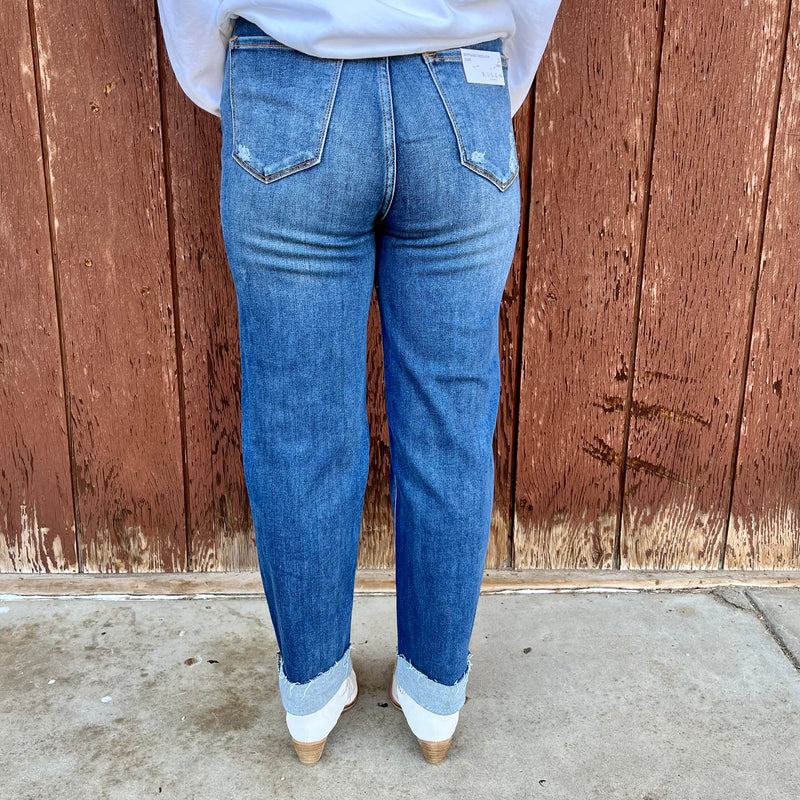 Risen High waisted medium wash Boyfriend Crossover fit jeans with large rips and distressing. Perfect to cuff over sneakers or booties!  65%  cotton, 32% polyester, 1.5% spandex  rise: 11"  inseam: 26"