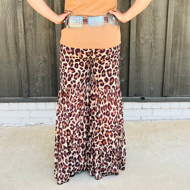 These tri brown colored leopard print bells are legit!!! They are the most comfortable fit and look absolutely perfect on. The Tiered Leg design is perfect. They look like a skirt but are pants. You will not be disappointed!!!  96% Polyester, 4% Spandex  XS,S,M,L,XL 