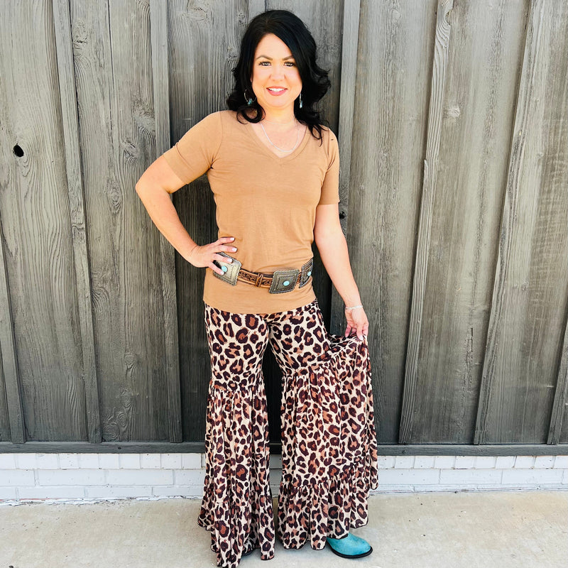 These tri brown colored leopard print bells are legit!!! They are the most comfortable fit and look absolutely perfect on. The Tiered Leg design is perfect. They look like a skirt but are pants. You will not be disappointed!!!  96% Polyester, 4% Spandex  XS,S,M,L,XL 