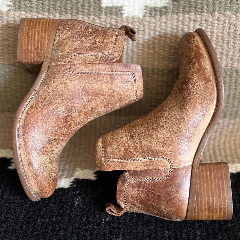 Distressed, uneven top, and beautifully stitched leather tan ankle booties with a 2" heel, perfect for the cooler seasons!