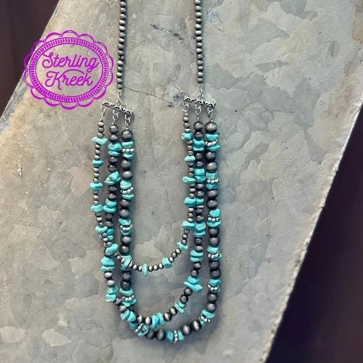 Glam up your look with this one-of-a-kind necklace featuring layers of turquoise stones and Navajo pearls! Whether you're ready to hit the town or just catching up with friends, this statement-making piece will have you looking sharp and feeling comfortably chic!  LENGTH: 13"  ADJUSTABLE CHAIN: 4"