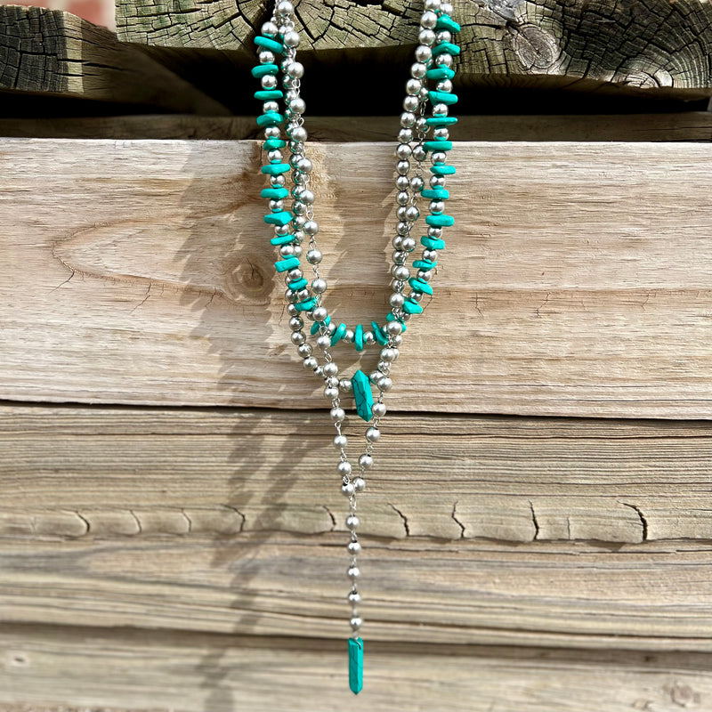 Add some serious style to your outfit with this ROCK IT Western necklace! Featuring three layers of turquoise stones and silver pearls, it's sure to turn heads! Strut your stuff with this showstopper of a necklace and make an unforgettable impression. Yee-haw!  LENGTH 14.5"