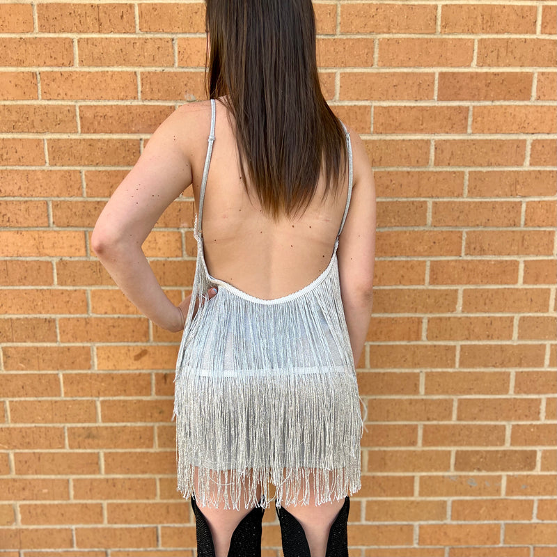 Turn heads in this showstopping backless dress! Adorned with glamorous fringe and tassels, you'll look stunning and fashionable for any dressy event or night out. Step out and make a statement with this flattering and fabulous dress! Available in silver and black. 