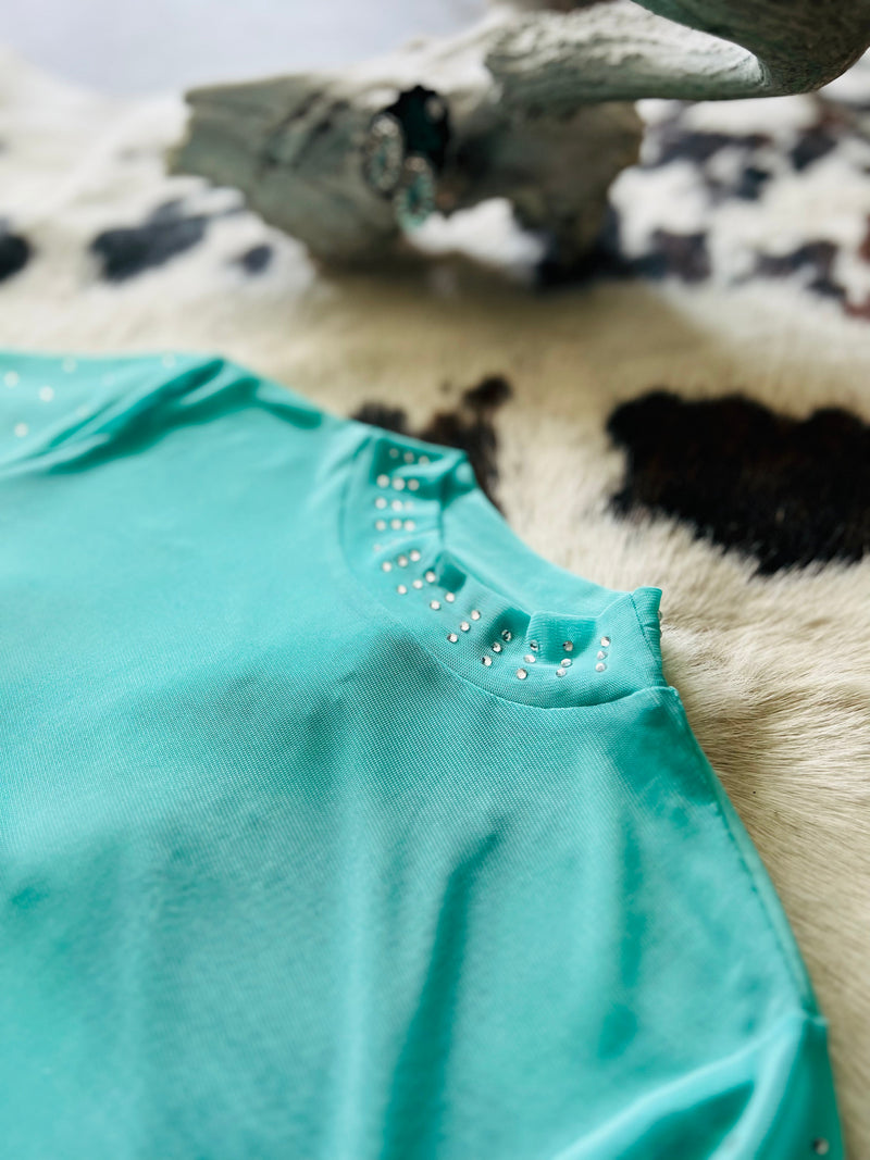 Make heads turn in our Turquoise Trouble Top! This fun and feminine piece features a turquoise long sleeve mesh top with rhinestones on the arms and neckline for that extra "wow" factor. So why wait? Pop it on, sparkle your way out the door and make your own turquoise trouble!  96% POLYESTER 4% SPANDEX