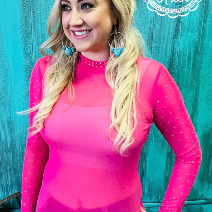 This chic top features pink fabric and rhinestone accents along the neckline and sleeves. A sheer mesh neckline completes the look, creating a stylish and eye-catching piece. Wear it on its own, or as a layering piece under a tee. A perfect addition to your wardrobe.  96% POLYESTER 4% SPANDEX