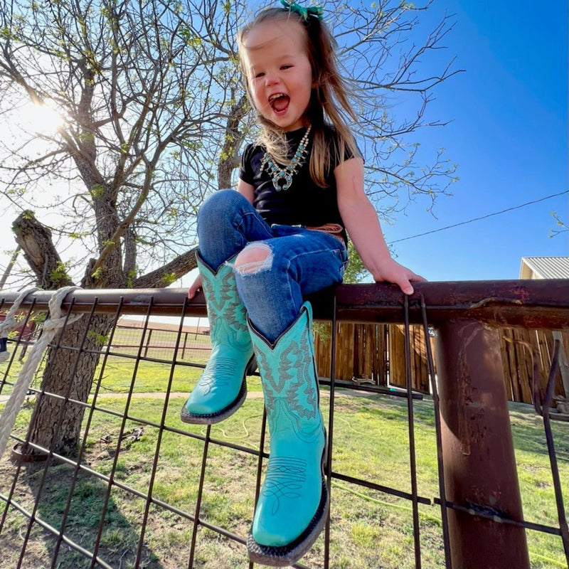 By Tanner Mark  For your little rodeo princess! Toddler sized turquoise leather boots. Midcalf shaft height, square toe.