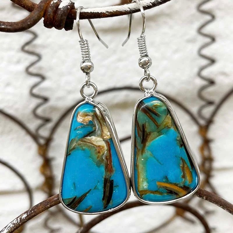 he Gorgeous Turquoise Tango Earrings by Sterling Kreek are on of a kind. The larger pear shaped design with the Turquoise Stone are unique. The beautiful brown accents add tons of color. You will fall in love with these earrings I assure you!!!  2" in total length from ear hook!