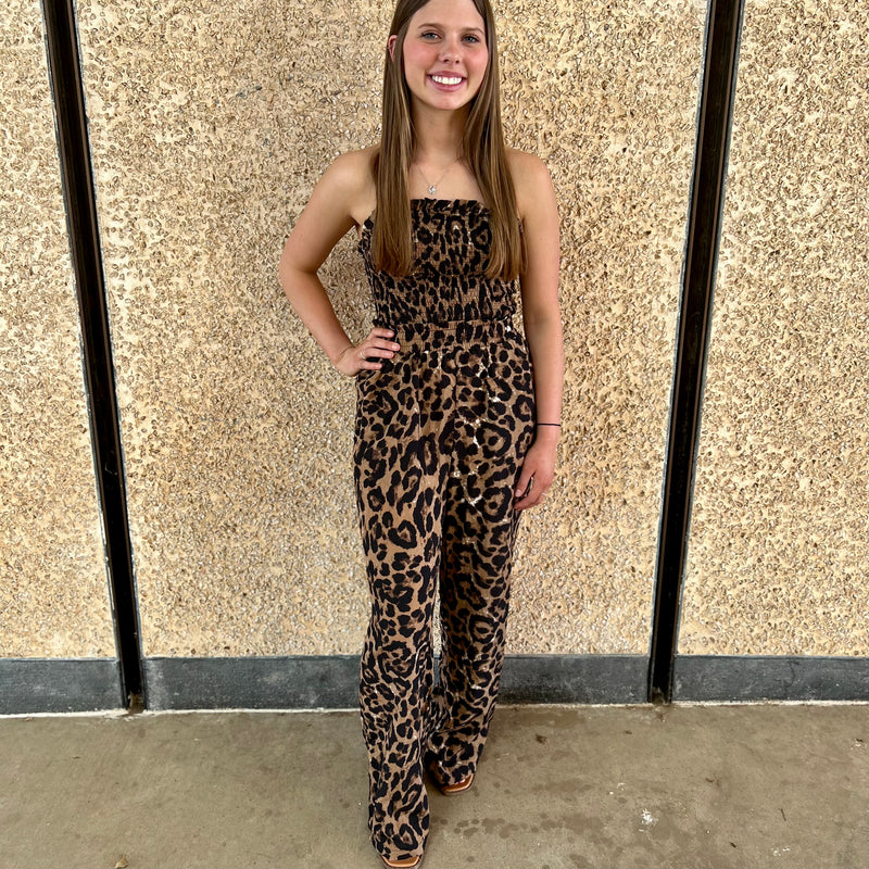 Glam up your wardrobe with the Back of the Leopard Jumpsuit! This daring piece features a halter neck, smocked bust and a strappy backless silhouette for an effortlessly edgy look. Go bold and unleash your wild side with an elastic fit that will have you feeling trendy and confident. Show who's boss and dominate the street in this show-stopping jumpsuit!