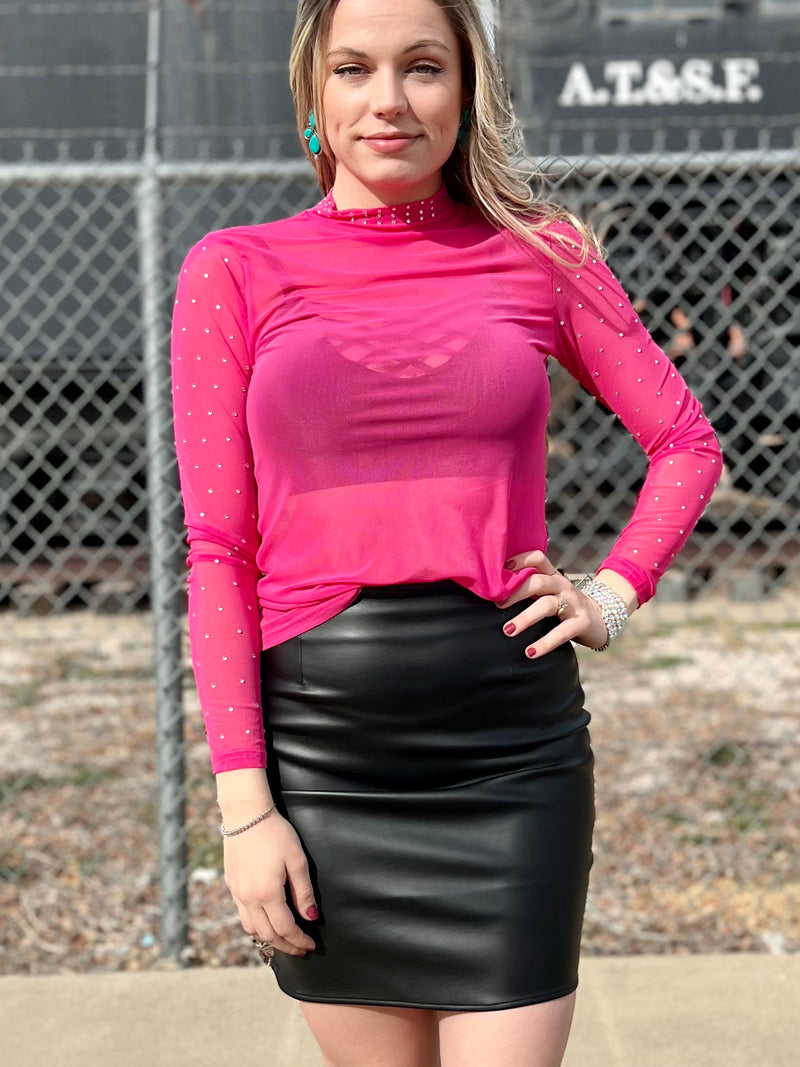 This chic top features pink fabric and rhinestone accents along the neckline and sleeves. A sheer mesh neckline completes the look, creating a stylish and eye-catching piece. Wear it on its own, or as a layering piece under a tee. A perfect addition to your wardrobe.  96% POLYESTER 4% SPANDEX