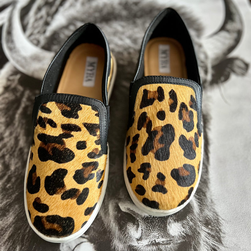 By Myra  Give your feet some style with these classic leopard hair on hide leather flat sneakers. They'll be your go-to pick for casual office days, shopping, or dress them up for a night on the town.   True to size, if between sizes size down