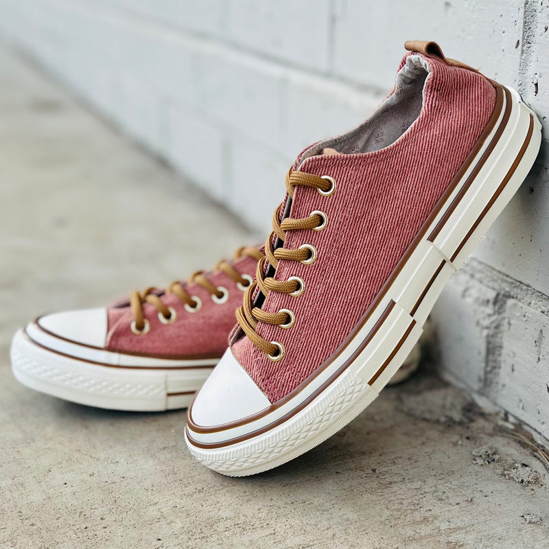 These sneakers are not only cute and stylish, but the comfy as all get out! The super cushioned foot bed offers optimal comfort. Ideal for everyday wear. The rubber sole ensures stability with every step. The upper shoe is a rust/light red color and is a canvas like material. 