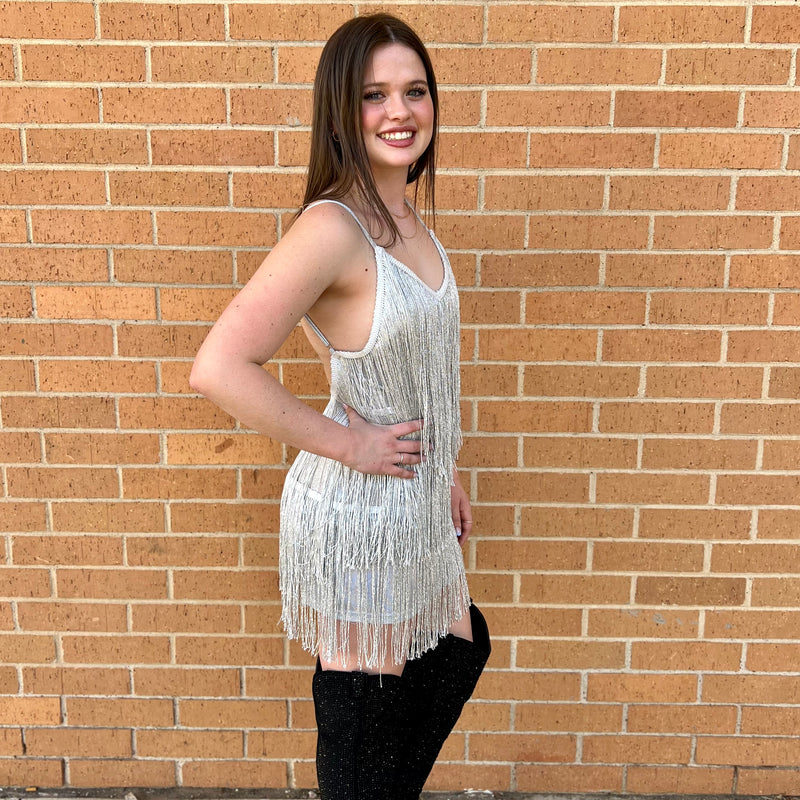 Turn heads in this showstopping backless dress! Adorned with glamorous fringe and tassels, you'll look stunning and fashionable for any dressy event or night out. Step out and make a statement with this flattering and fabulous dress! Available in silver and black. 