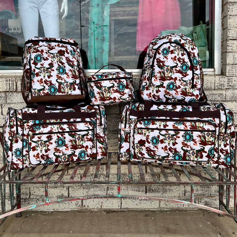 Pack your spurs and rope and hit the road in style with this Cowgirl Ranch Large Duffel Bag! Featuring a bold brown and cream cow print, wild western-style turquoise conchos, and a crafty cow skull adorned with feathers.  You'll look like a rodeo star no matter where you're headed! Saddle up and make a statement with this dashing duffle bag!   L23" x W10.5" x H12.5". 