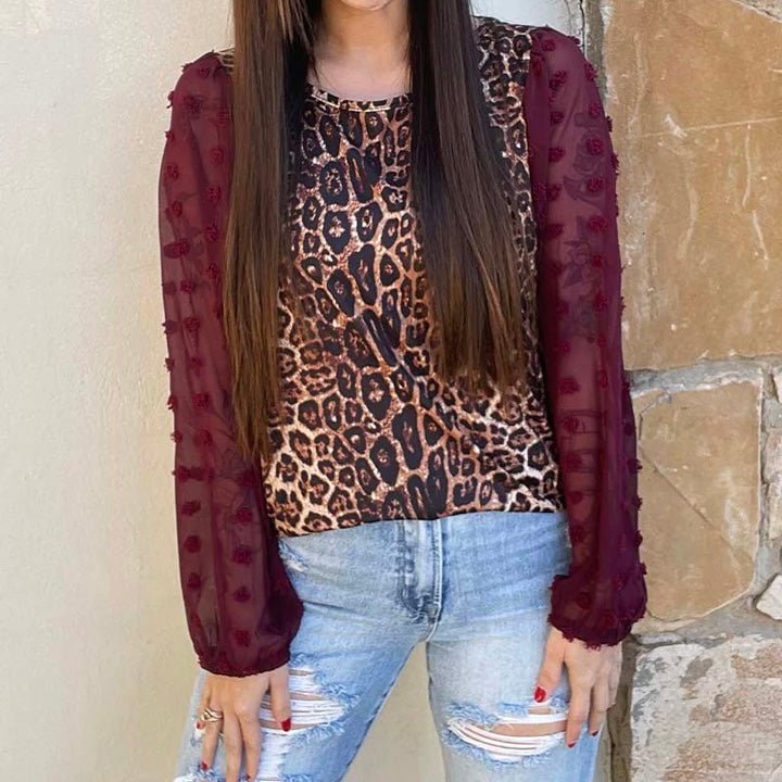This Kitty In A Cradle Top by Sterling Creek is beautiful. The gorgeous leopard print top with red wine colored sheer dot sleeves sure one to catch the eye. The fabric is butter soft and a top you would be comfortable in all day.  32% Cotton, 56% Rayon, 12% Spandex   XS, S, M, L, XL