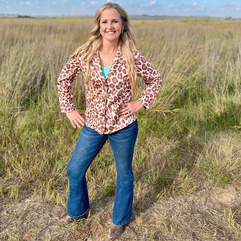 This Leopard Born Wild Blazer is a SHOW STOPPER!! It would be precious dressed up or casual. The Tri Color Leopard Print is the real deal. You wont be disappointed with this blazer. The turquoise and Silver Concho Buttons make this Blazer shine!!!  90% Polyester, 10% Spandex  XS, S,M,L XL
