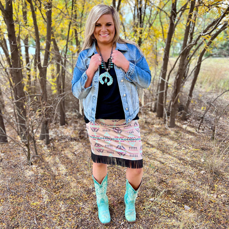 The Cheyenne Skirt by Sterling Kreek is adorable. The multiple colored Aztec print with the black fringe around the bottom completes the look of this cute skirt.  This skirt is so lightweight and butter soft. This skirt has so many options to either be dressed up with a jacket and boots or a simple top.  92% Polyester, 8% Spandex  XS, S, M, L, XL