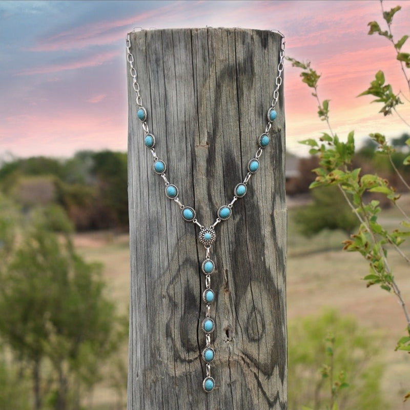 Dainty lariat style Y-necklace with oval turquoise stone conchos on a silver plated chain.