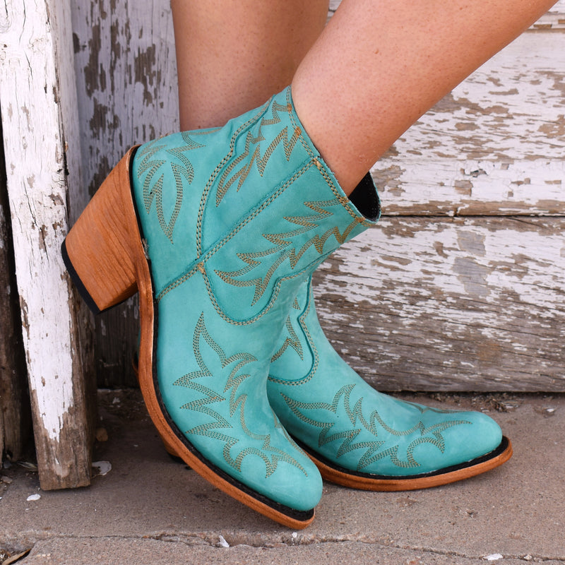 Turquoise nubuck leather western booties with gold decorative stitching. Inner ankle zipper.