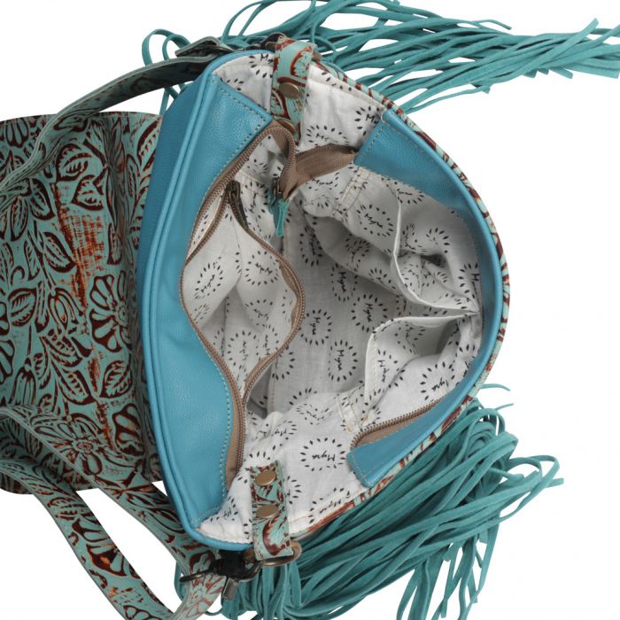 Turquoise tooled leather front and strap, with bright turquoise back, bottom, and suede side fringe as well as front flap tassel. Front flap is hair on hide with magnetic button closure and tear drop shaped feather design tooled leather detail. Top zipper closure and removable and adjustable strap.