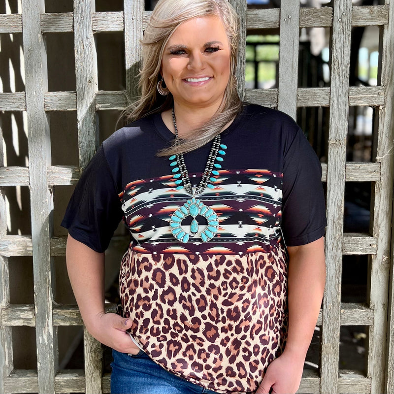 This colorful Sane Wagon Top is a comfort fit Top. The Multi colored Aztec Print is paired perfect together and the tri colored leopard on the bottom makes this Top stand out. The top material is so soft and comfortable.   26% Cotton, 69% Polyester, 5% Spandex  XS, S, M, L, XL