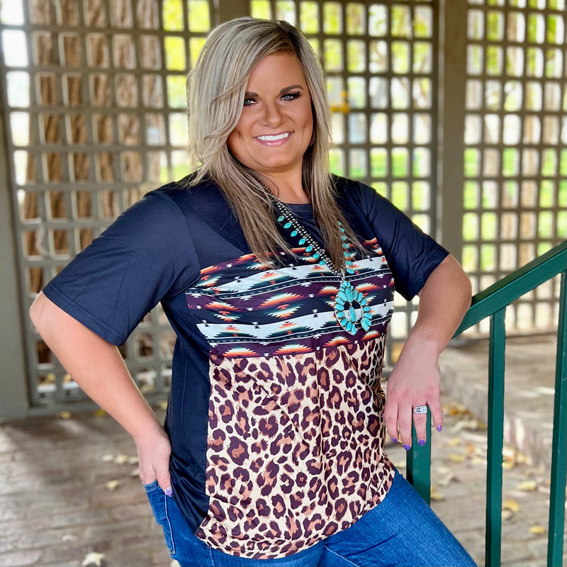 This colorful Sane Wagon Top is a comfort fit Top. The Multi colored Aztec Print is paired perfect together and the tri colored leopard on the bottom makes this Top stand out. The top material is so soft and comfortable.   26% Cotton, 69% Polyester, 5% Spandex  XS, S, M, L, XL