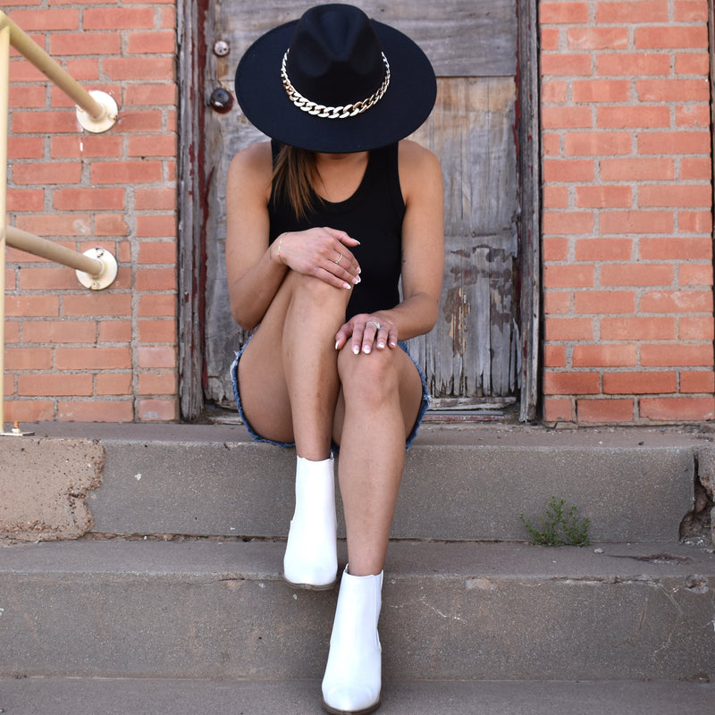 White faux leather croc embossed booties with inner and outer ankle elastic gusset, almond toe, and stacked heel.
